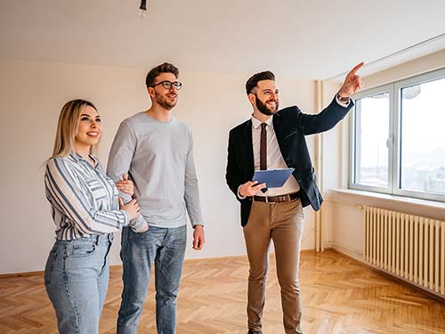 A young couple checking out a house for sale.